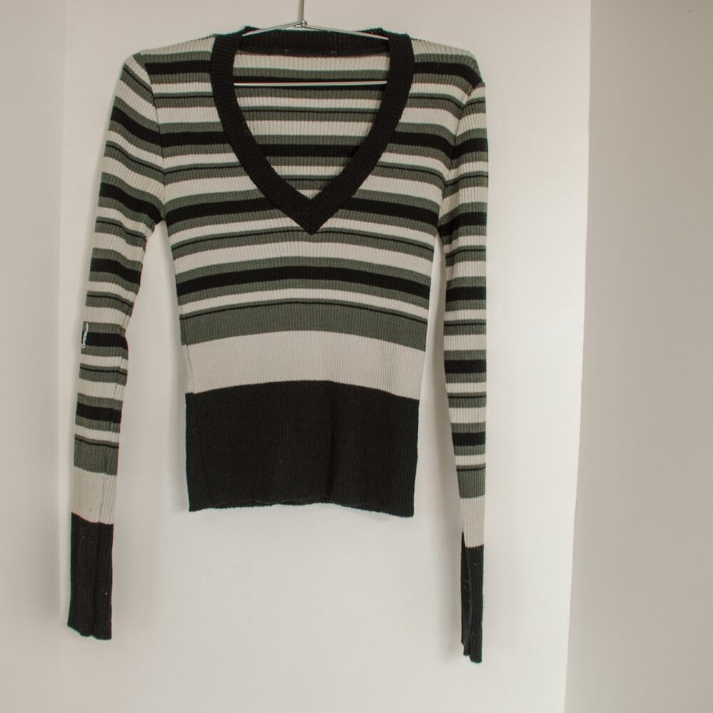Black, White, Grey horizontally striped, long-sleeved sweater with a V-neck.